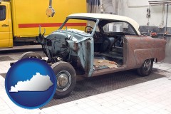 a vintage automobile in an auto body shop - with KY icon