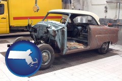 a vintage automobile in an auto body shop - with MA icon