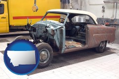 a vintage automobile in an auto body shop - with MT icon