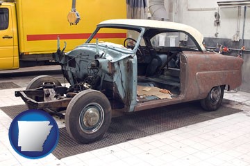 a vintage automobile in an auto body shop - with Arkansas icon