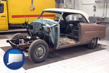 a vintage automobile in an auto body shop - with Connecticut icon