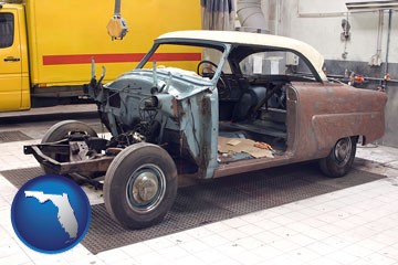a vintage automobile in an auto body shop - with Florida icon