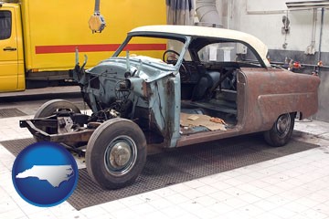 a vintage automobile in an auto body shop - with North Carolina icon