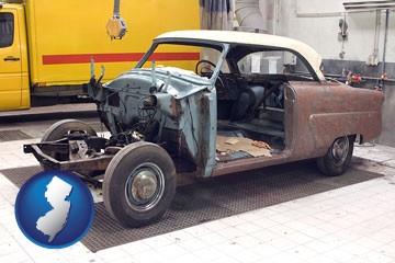 a vintage automobile in an auto body shop - with New Jersey icon