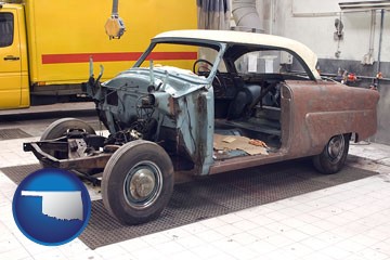 a vintage automobile in an auto body shop - with Oklahoma icon
