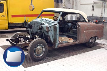 a vintage automobile in an auto body shop - with Oregon icon