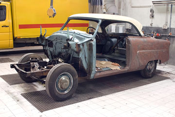 a vintage automobile in an auto body shop