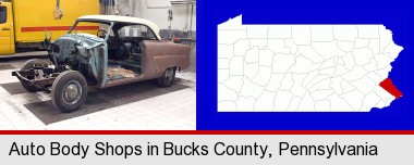 a vintage automobile in an auto body shop; Bucks County highlighted in red on a map