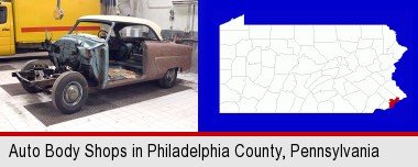 a vintage automobile in an auto body shop; Philadelphia County highlighted in red on a map
