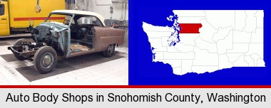 a vintage automobile in an auto body shop; Snohomish County highlighted in red on a map