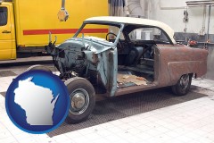 a vintage automobile in an auto body shop - with WI icon
