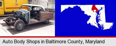 a vintage automobile in an auto body shop; Baltimore County highlighted in red on a map
