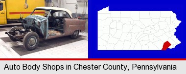 a vintage automobile in an auto body shop; Chester County highlighted in red on a map